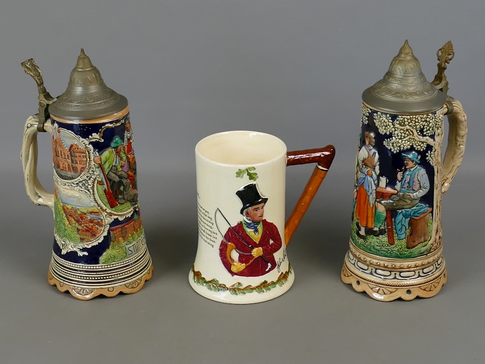 Two German ceramic musical tankards with pewter lids, both approx 10.5" tall and playing typical