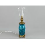 An impressive vintage teal blue/green glazed decorative ceramic and brass table lamp upon a heavy