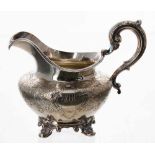 Victorian silver cream jug, of squat baluster form, the body finely chased raised on four