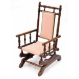 Rare American walnut child's rocking chair, with turned spindles and pink fish scale pattern