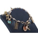 Gold charm bracelet with assorted charms, mostly marked '14k', 18gm, 7.25" long