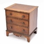 Small mahogany and oak chest of three long graduated drawers, the mahogany top within chequered