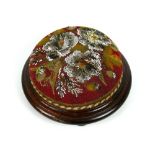 Victorian mahogany and beaded tapestry footstool, on three bun feet, 11.5" diameter (some losses