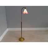 Adjustable brass floor lamp with Tiffany style glass shade, 56" tall