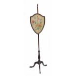 Victorian mahogany pole screen, with adjustable shield shaped panel worked with a floral display,