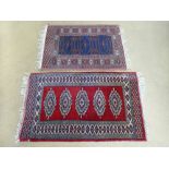 A vintage Eastern blue ground prayer mat, 31" x 25", together with a similar red ground mat 37" x