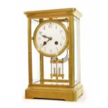 French brass four glass two train mantel clock striking on a gong, the 4" white dial over a
