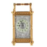 Carriage clock striking on a gong, the 2.25" raised cream chapter ring within a foliate engraved