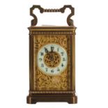 Attractive carriage clock striking on a gong, the 2" cream chapter ring enclosing a foliate filigree