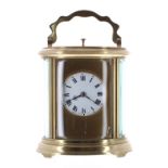 Repeater carriage clock striking on a gong, the 2" white dial within a gilt mask and oval brass