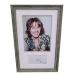 George Harrison - signed envelope framed and mounted with a picture of George Harrison, 21.5" x 14"