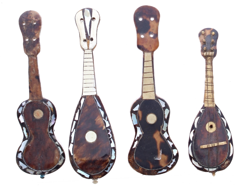Two miniature tortoiseshell and mother of pearl inlaid Neapolitan mandolins; also two similar