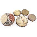 Four interesting early tambourines each with hand decorated rims, one with painted skin depicting an