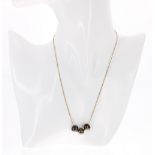 Slender 9ct necklace with three sliding iridescent cultured pearls, 4.8gm, the pearls each 10mm x