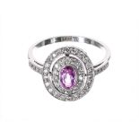 Pretty 18ct white gold pink sapphire and diamond halo set oval cluster ring, the sapphire .36ct,