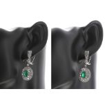 Very impressive pair of 18ct white gold oval shaped emerald and diamond cluster drop earrings