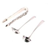 Pair of Victorian Irish silver nips/tongs, with cast decoration of flowers within scroll border,