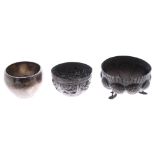 Indian white metal lobed bowl, dense foliate cast decoration, raised on three stylised fish feet,