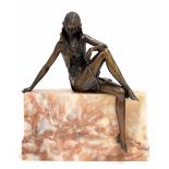 Art Deco bronze figure of a lady seated on a wall, upon a marble wall base, monogrammed to