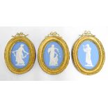 Three framed Wedgwood Jasperware oval miniature plaques in giltwood frames, each depicting a