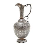 Good Kashmir white metal ewer, profusely decorated with flowers and vines, raised on a circular foot