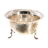 George VI silver bowl, with a card-cut rim upon three feet, make possibly S Blackensee & Son Ltd.