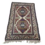 Turkish Melas rug, decorated with twin lozenge within geometric borders, 80" x 50" approx