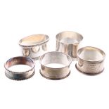 Five hallmarked silver napkin rings, 4.2oz t, three with retail boxes