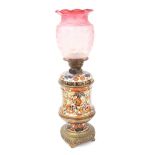 Victorian Taylor, Tunnicliffe & Co and T. Hinks & Son oil lamp, with a foliate pottery body and gilt
