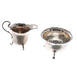 George VI silver cream jug and sugar bowl, with moulded shaped rims, each raised on three feet,