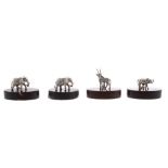 Four Patrick Mavros silver menu holders, modelled as African wild animals, mounted upon oval