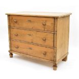 19th century stripped pine chest of three drawers, with applied turned pilasters upon turned feet