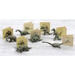 Seven SRG (Sell Rite Gifts) cast bronze dinosaur figures, complete with original information