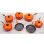 Le Creuset - set of four graduated saucepans with lids, largest 22cm; together with an oven dish