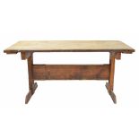 Pitch pine trestle table, the planked top with cleated ends, upon rectangular trestle supports
