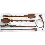 Large African novelty carved wooden spoon and fork, each with elephant head decoration to the