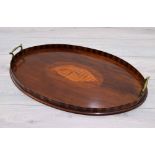 Edwardian oval mahogany inlaid twin handled gallery tray, inset with a conch shell paterae to the