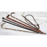 Five walking canes/sticks, one ebonised with hallmarked silver top, longest 36" long; together