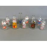 Collection of vintage glass milk bottles with various transfer printed advertisements (11)