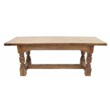 Good solid polished elm refectory table, the triple planked top with cleated ends over a panelled