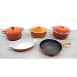 Five enamelled cast iron pots/pans; including Coucances oval dish with cover and frying pan, open
