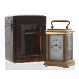 Reproduction miniature carriage clock timepiece, within a stepped brass case, 3.75" high (key); also