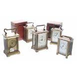 Five various carriage clock timepieces, two with outer Morocco leather travelling cases, all in need