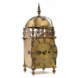 English brass double fusee lantern clock, the 6.5" chapter ring enclosing a foliate engraved