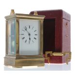 Repeater carriage clock striking on a gong, within a stepped case, surmounted by an ornate handle (