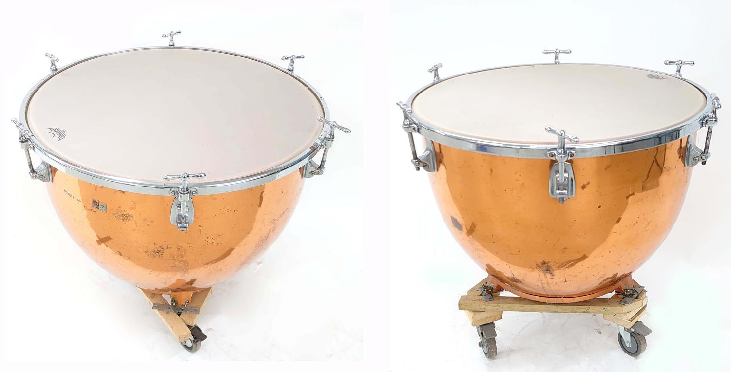 Pair of Premier hand tuned copper timpani drums, 28" and 25", each fitted upon wooden trolley