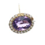 15ct amethyst and seed pearl oval brooch with safety chain, 3.5gm, 16mm x 19mm (one pearl missing)