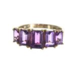 Amethyst 9ct five stone ring in a stepped setting, width 8mm, 2.4gm, ring size M