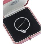 Attractive Edwardian white metal diamond set circular open-work brooch with a floral spray, set with