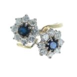18ct sapphire and diamond double cluster cross-over design ring, each cluster with a single sapphire